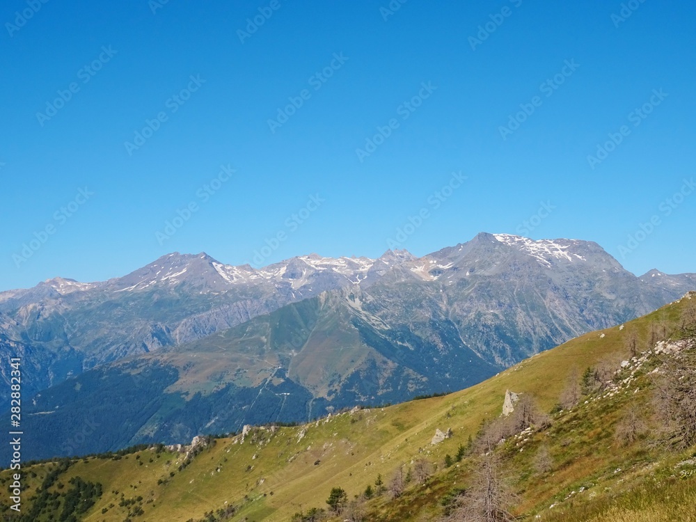 Fototapeta premium Nature, meadows and peaks that characterize the landscape of the Italian Alps in Val di Susa, near the town of 