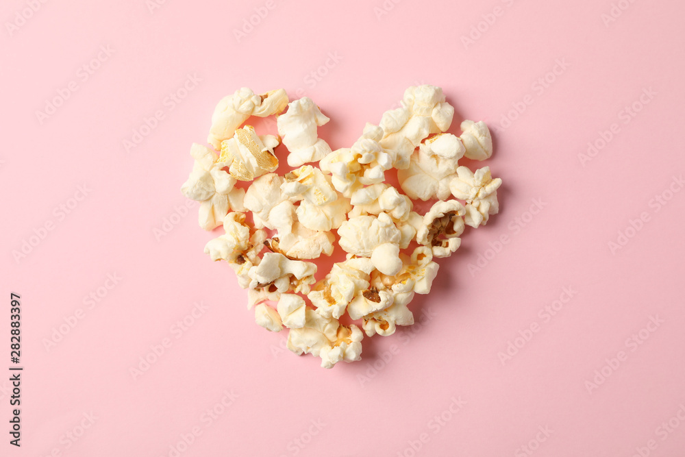 Flat lay composition with popcorn heart on pink background, space for text Flat lay composition with popcorn heart on pink background, space for text