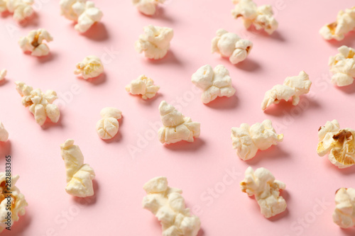 Flat lay composition with popcorn on pink background, closeup