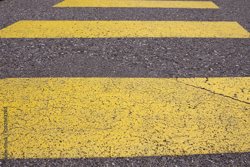 Fototapeta premium Crosswalk yellow lines on the road. zebra yellow pedestrian crossing