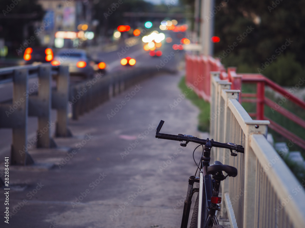 Mountain bike in the evening stands on the bridge. Summer evening trips Mountain bike in the evening stands on the bridge. Summer evening trips