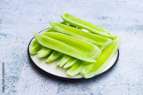 фотографія Green cucumber slices. Fresh, ripe, cut cucumbers on plate.