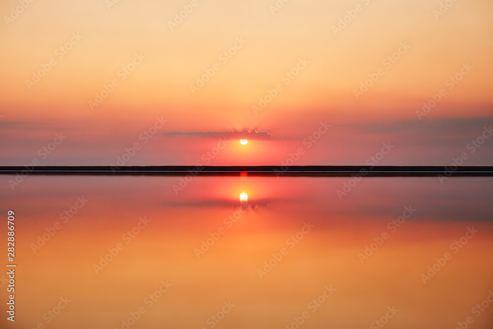 Beautiful orange sunset over the lake