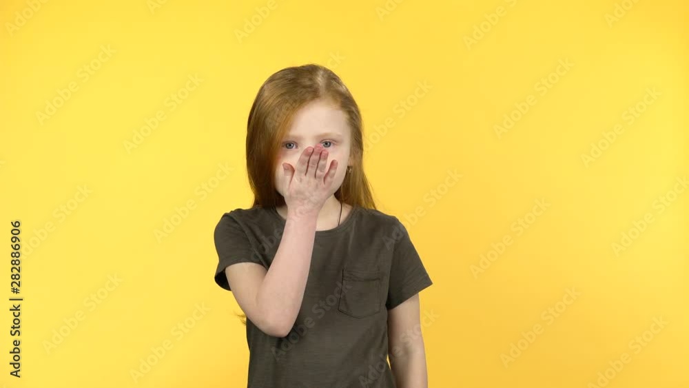 Little girl posing and blows kiss to someone
