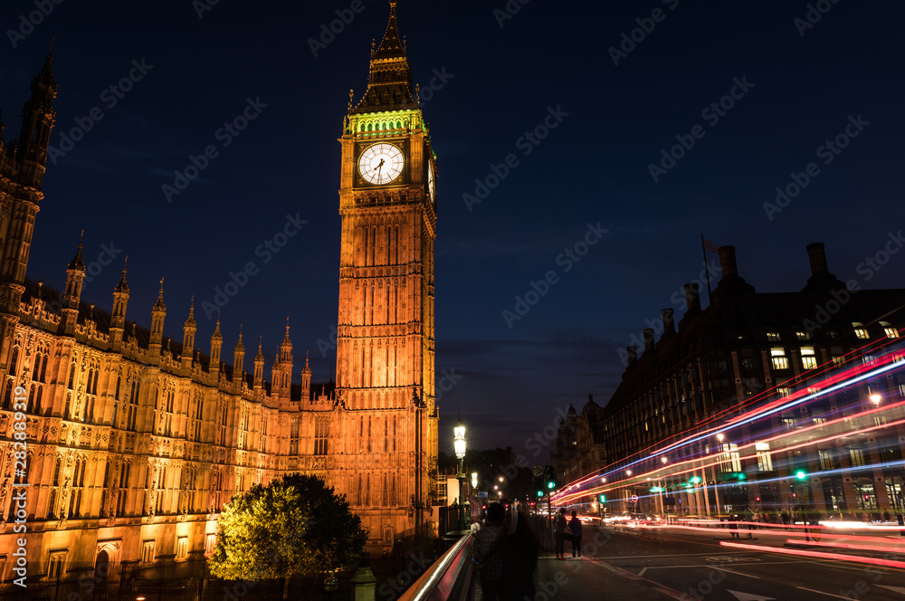 Big Ben London England at night and Bus and Car Light Trails