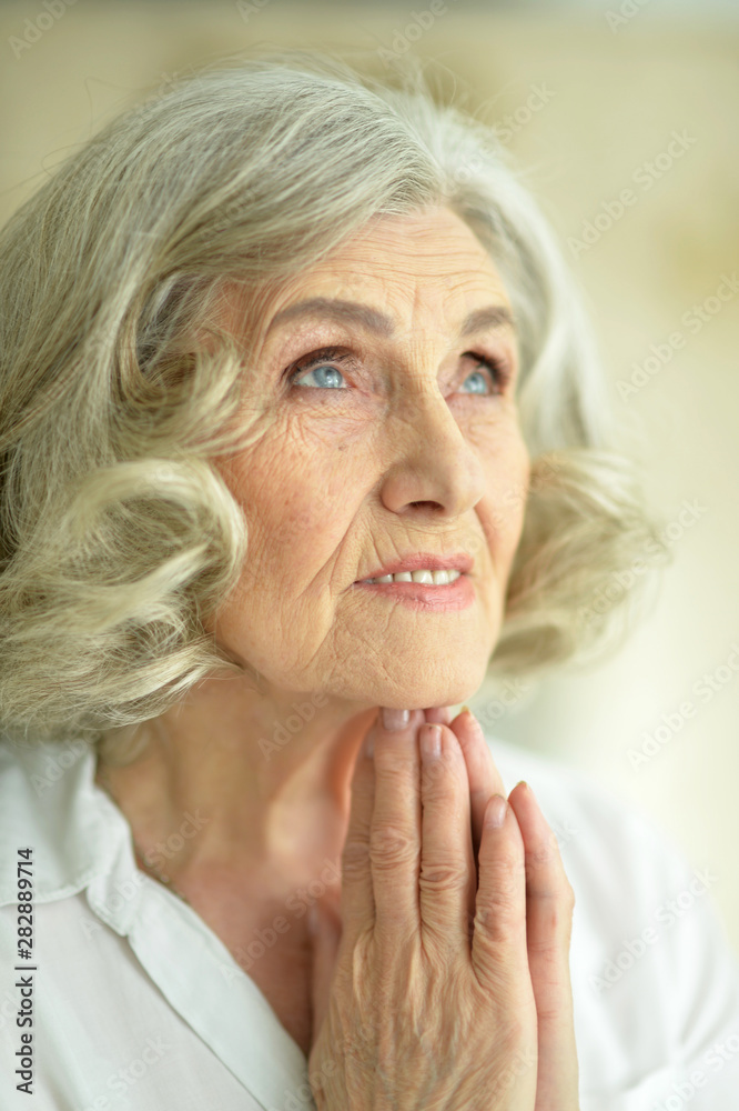 Portrait of senior woman posing and praying Portrait of senior woman posing and praying