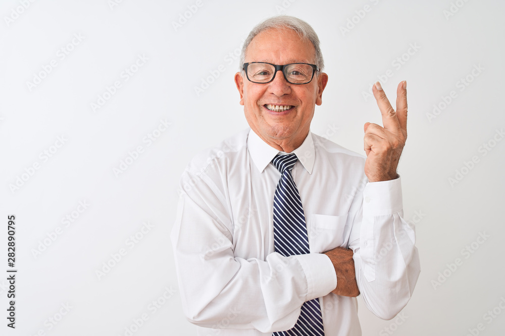 Senior grey-haired businessman wearing tie and glasses over isolated white background smiling with happy face winking at the camera doing victory sign. Number two. Senior grey-haired businessman wearing tie and glasses over isolated white background smiling with happy face winking at the camera doing victory sign. Number two.
