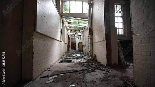 Abandoned Corridor With Debris And Broken Windows