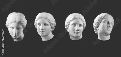Four gypsum copy of ancient statue Venus head isolated on black background. Plaster sculpture woman face.