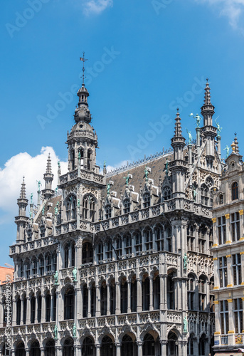 Brussels, Belgium - June 22, 2019: Gray stone monumental palace with spires and statues on Grand Place, called Maison du Roi, Kings house, Broodhuis, and now Museum of City of Brussels.