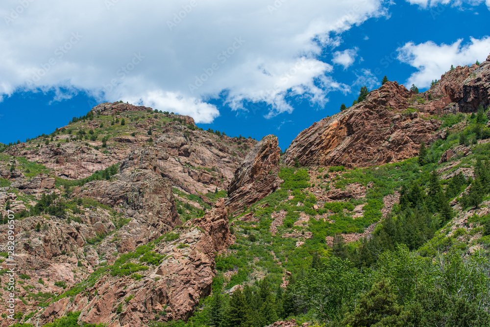 Low angle landscape of rock mountains and greenery on the Shelf Road near Cripple Creek, Colorado