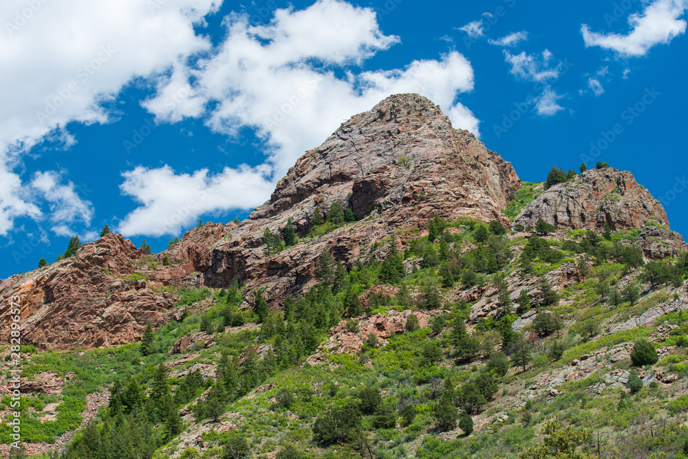 Low angle landscape of rock mountains and greenery on the Shelf Road near Cripple Creek, Colorado