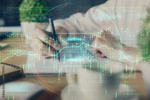 Wallpaper Mural Financial forex graph displayed on hands taking notes background. Concept of research. Multi exposure Torontodigital.ca