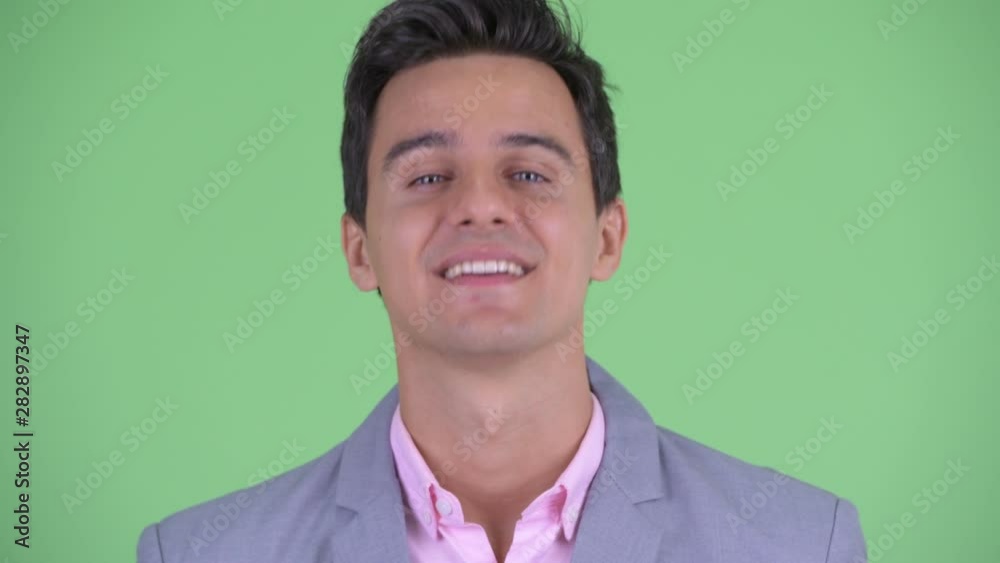 Face of happy young handsome businessman nodding head yes Face of happy young handsome businessman nodding head yes
