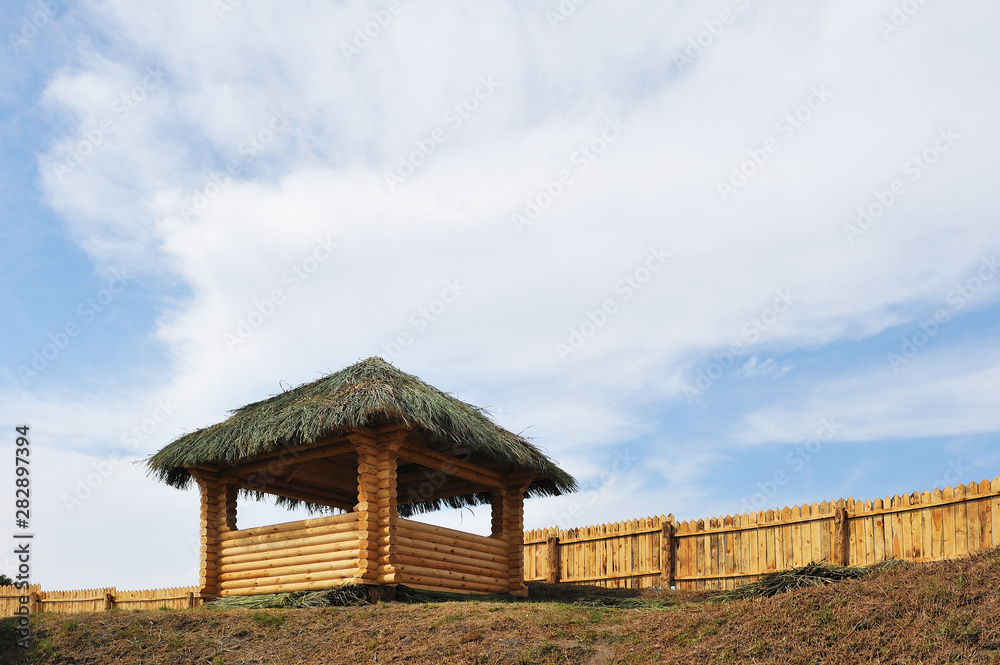 Medieval defensive fortification of a wooden watchtower and fence. Fort. Fortress Medieval defensive fortification of a wooden watchtower and fence. Fort. Fortress