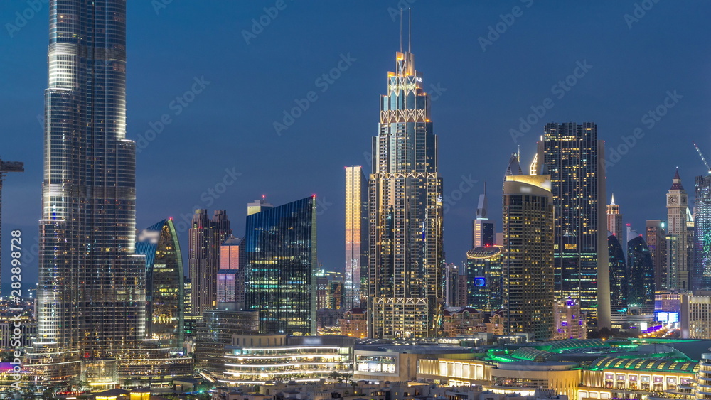 Naklejka premium Dubai Downtown skyline day to night timelapse with towers paniramic view from the top in Dubai