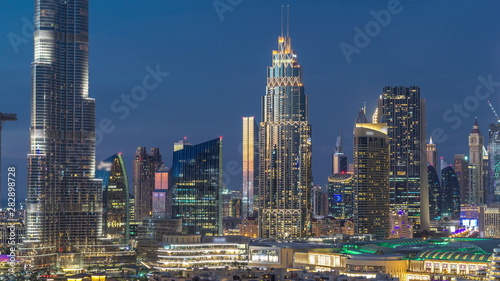 Dubai Downtown skyline day to night timelapse with towers paniramic view from the top in Dubai