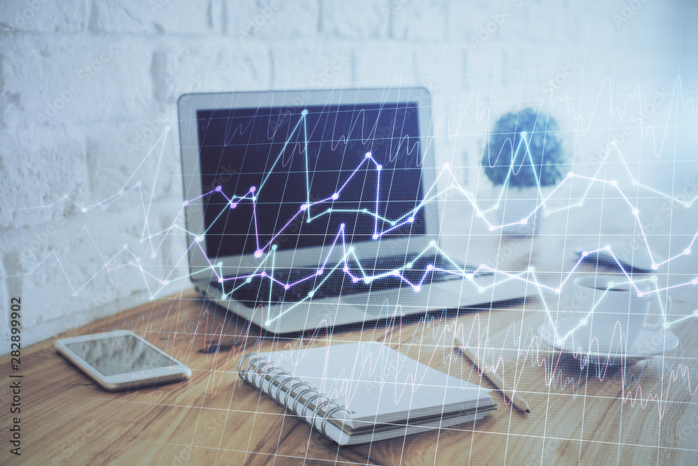 Double exposure of graph and financial info and work space with computer background. Concept of international online trading. Double exposure of graph and financial info and work space with computer background. Concept of international online trading.