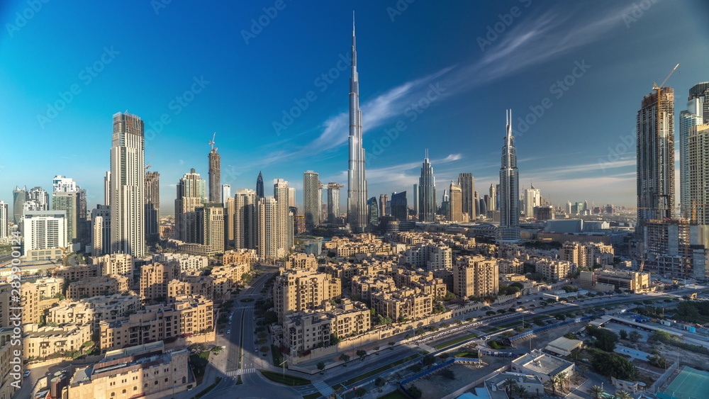 Dubai Downtown skyline timelapse with Burj Khalifa and other towers during sunrise paniramic view from the top in Dubai