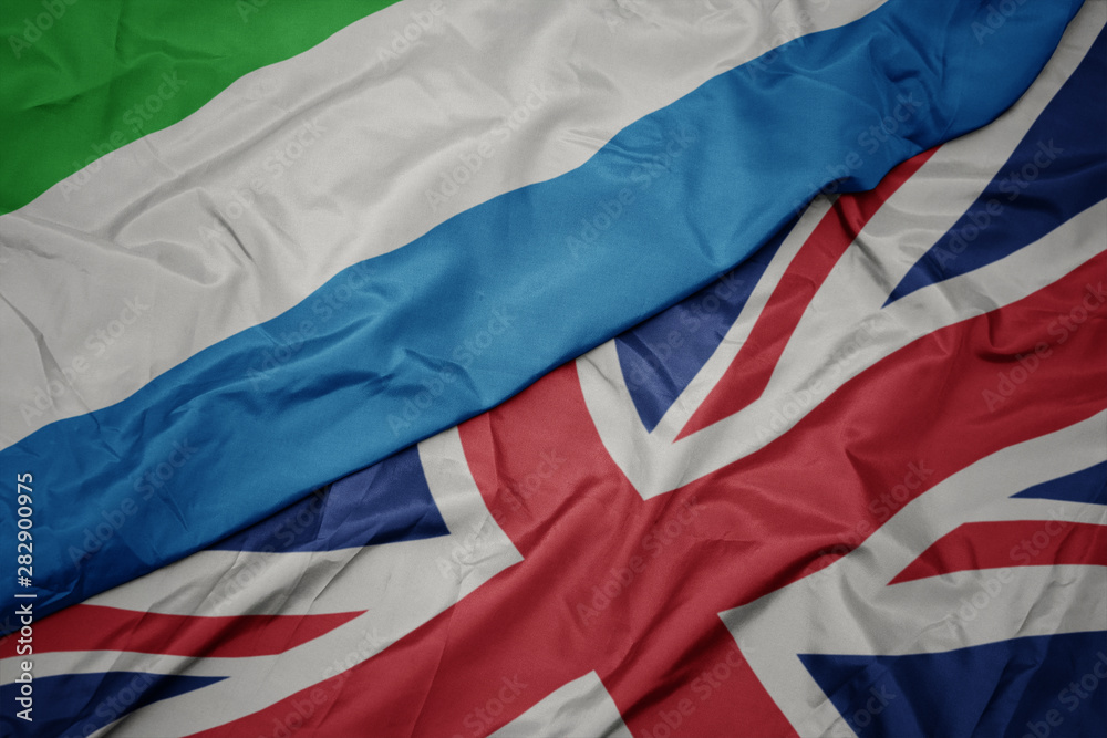 waving colorful flag of great britain and national flag of sierra leone.