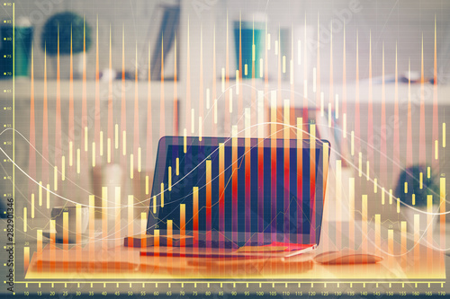 Forex market graph hologram and personal computer on background. Multi exposure. Concept of investment. © peshkova