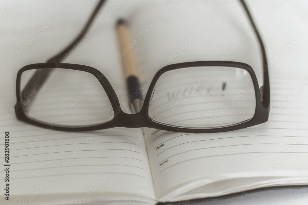black glasses lie on the book on the table, rest in the process of education black glasses lie on the book on the table, rest in the process of education