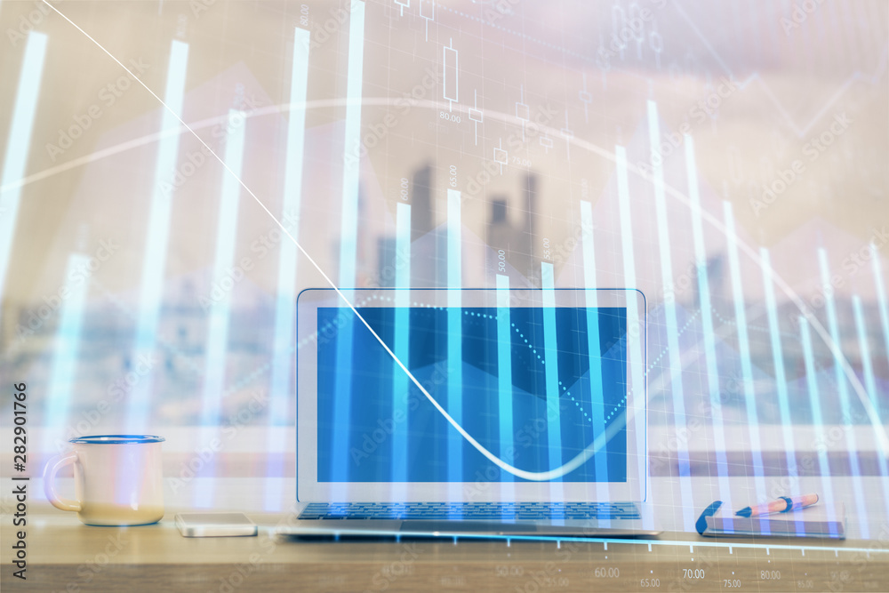 Forex Chart hologram on table with computer background. Double exposure. Concept of financial markets. Forex Chart hologram on table with computer background. Double exposure. Concept of financial markets.