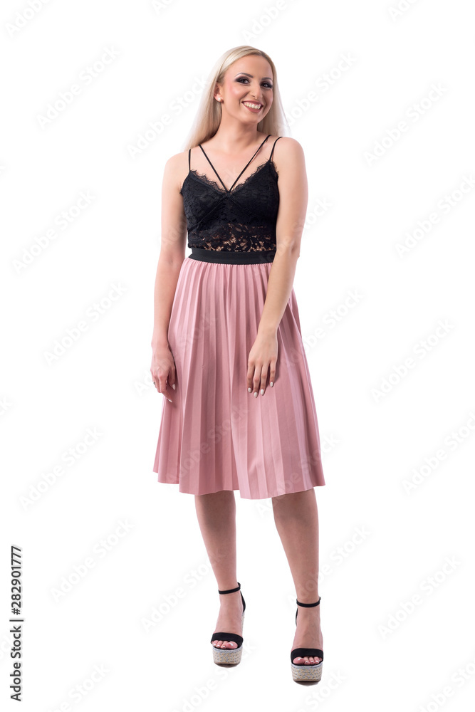 Joyful smiling young blonde woman fashion model in long pleated skirt. Full body isolated on white background. 