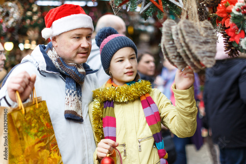 Father with daughter selecting Christmas decoration