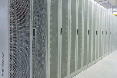 White network cabinets neatly arranged in the data center room