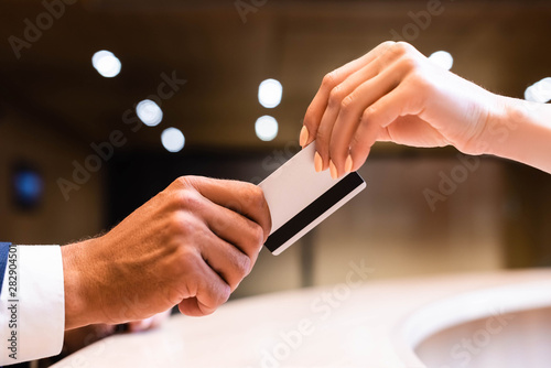 cropped view of man and woman holding credit card