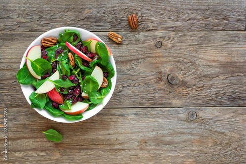 Spinach, apple salad with  pecan nuts and dry cranberries