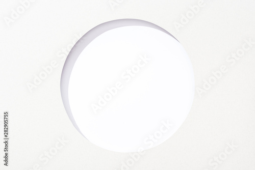 cut out round hole in white paper on white background