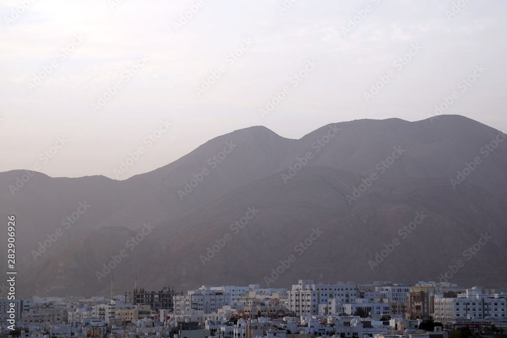 Dawn breaks over Muscat, capital of Oman, on 8 August 2017. The city is characterised by white-washed, low-rise houses and offices and is flanked by the Western Al Hajar mountains to the south.