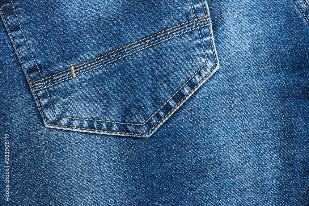 Fragment of blue denim with part of pocket. Fragment of blue denim with part of pocket.