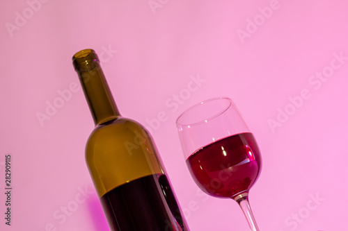 A bottle of wine and a glass