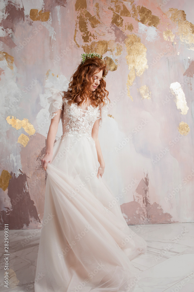 Elegant red-haired girl bride. Young beautiful woman in wedding dress Elegant red-haired girl bride. Young beautiful woman in wedding dress