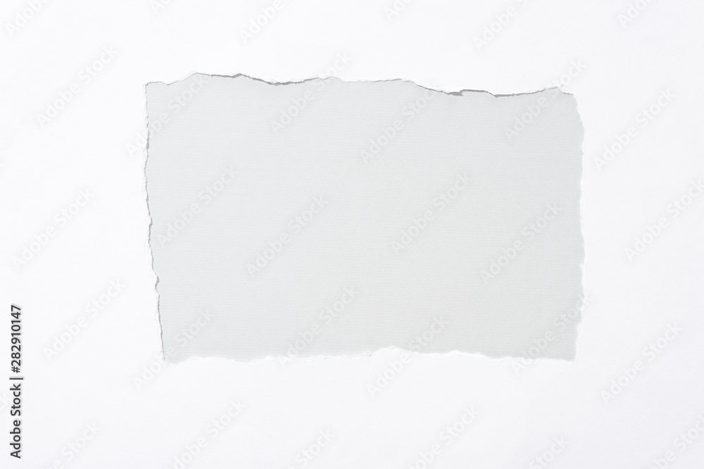grey background in white torn paper hole