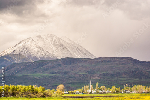 Mount Kose in Turkey near Agri with snow and green meadows photo