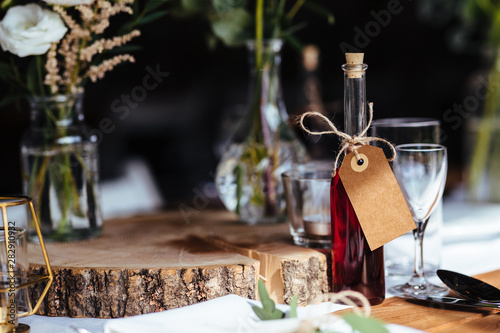 Classy wedding setting.Table setting. Fancy bottle with empty name tag.