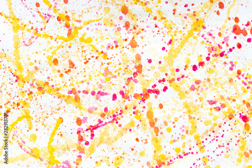 multicolored watercolor blots on white paper background