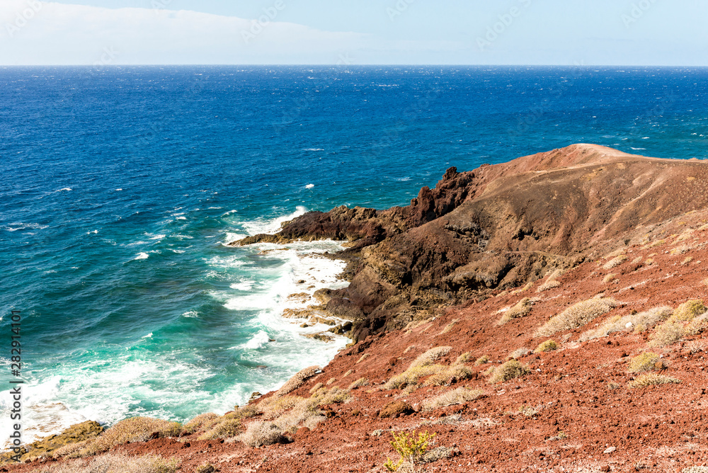 Atlantic ocean waves at the base of Mount Bocinegro coastline near El Medano town, Tenerife, Spain