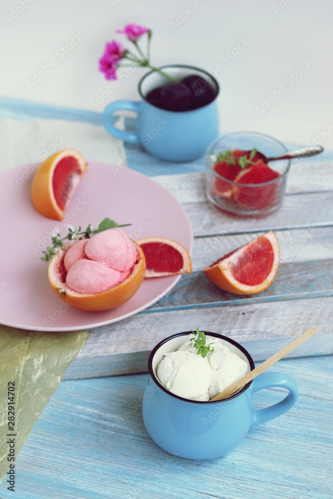 Natural ice cream, grapefruit, basil on a wooden table, tasty and healthy dessert, seasonal food Natural ice cream, grapefruit, basil on a wooden table, tasty and healthy dessert, seasonal food