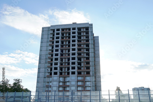 A multi-storey building is under construction. Skeleton of a building without windows. Real estate under construction for housing