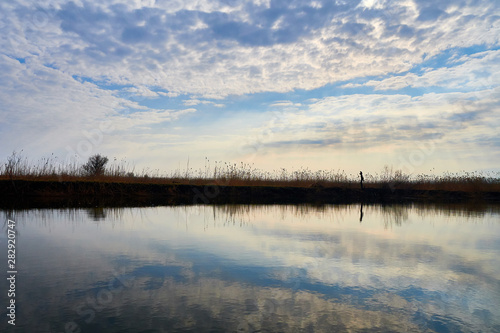 Reflection of sky in waters of Volga river © NeonBearPhoto