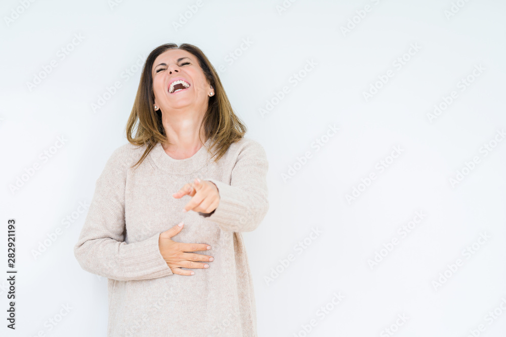 Beautiful middle age woman over isolated background Laughing of you, pointing to the camera with finger hand over chest, shame expression Beautiful middle age woman over isolated background Laughing of you, pointing to the camera with finger hand over chest, shame expression