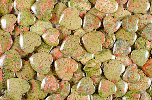 Bulk of unakite heart-shaped stones texture background