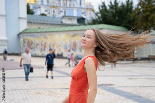 Attractive, Slim, Beautiful Girl Wearing White Shirt And Maxi Long Red Silk Fabric Skirt Fly And Wave In The Wind Walking. Fashion Concept