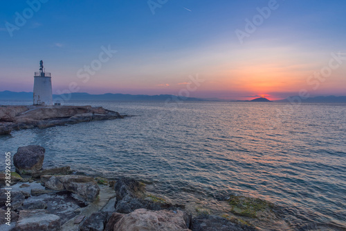 Old small lighthouse of the Aegina island, Saronic gulf, Greece, at sunset. © Aron M  - Austria
