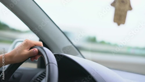 Wallpaper Mural Driver s hand on steering wheel against background of dashboard and windshield Torontodigital.ca